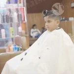 Boy sitting chair and getting haircut - Log, colour and B&W