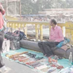 Man Selling Items on the Bridge in Haridwar - Log, colour and B&W