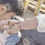 Boy Making a Tattoo with a pen in hand - Log, colour and B&W