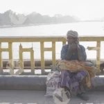 A Man is Sitting on The Bridge in Haridwar - Log, colour and B&W