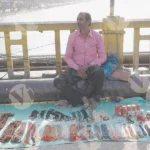 A Street Vendor in Haridwar Selling Religious Items tems - Log, colour and B&W