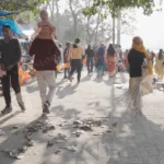 A Woman Cleaning the Path Beside the Haridwar River - Log, colour and B&W