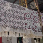 A Patterned Fabric with Tassels, which appears to be a Decorative Textile Product - Log, colour and B&W