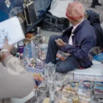 Man Selling Statue and Arts - Log, colour and B&W