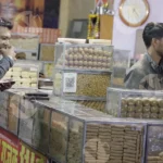 Man Eating Biscuits in a Bakery Shop - Log, colour and B&W