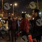 Person Looking for Electric Rickshaw in a Traffic - Log, colour and B&W