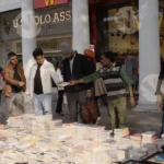 People Buying Books in Market - Log, colour and B&W