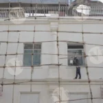 Workers on Scaffolding Engaged in the Maintenance or Renovation of a Building - Log, colour and B&W