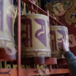 Spinning a Prayer  Wheel at a Buddhist Monastery