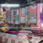 Woman Selling Stoles and Scarves - Log, colour and B&W