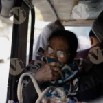 A Old Woman  Setting in a Auto - Log, colour and B&W