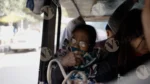 A Old Woman  Setting in a Auto - Log, colour and B&W