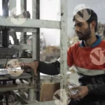 Man Collecting Paper Plates in a Factory - Log, colour and B&W