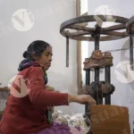A Woman is Shaping Paper and Making Plates with a Hand Machine - Log, colour and B&W
