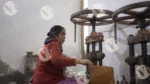 A Woman is Shaping Paper and Making Plates with a Hand Machine - Log, colour and B&W
