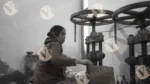 A Woman is Shaping Paper and Making Plates with a Hand Machine - Log, colour and B&W - Image 2
