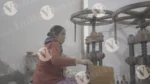 A Woman is Shaping Paper and Making Plates with a Hand Machine - Log, colour and B&W - Image 3
