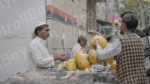 Man Buying Papaya - Log, colour and B&W