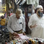 Man Buying Clothes in a Stall - Log, colour and B&W
