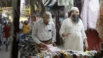 Man Buying Clothes in a Stall - Log, colour and B&W