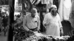 Man Buying Clothes in a Stall - Log, colour and B&W - Image 2