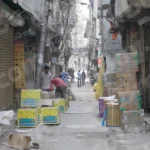 Man packing Things in a Street - Log, colour and B&W