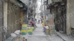 Man packing Things in a Street - Log, colour and B&W