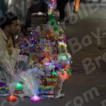 Man Selling Toys in a Street - Log, colour and B&W