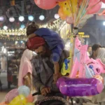 Man Selling Toys and Plying With Her Kid - Log, colour and B&W