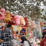 Man Selling Toys in a shop - Log, colour and B&W