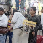 Boy Selling Locket & Necklace - Log, colour and B&W