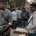 Man Selling Necklace in a Market - Log, colour and B&W