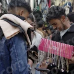 Boy Selling Necklace - Log, colour and B&W