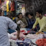 People Buying Clothes in a Market - Log, colour and B&W