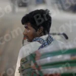 Man sitting in a Cycle Rickshaw - Log, colour and B&W