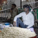 Man Selling Goods in a Street - Log, colour and B&W