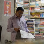 Man Reading Newspaper - Log, colour and B&W
