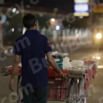 A Man with a Cart on a Street at night - Log, colour and B&W