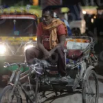Man Sitting On a Cycle Rickshaw - Log, colour and B&W
