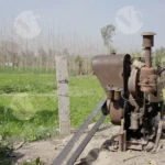 A Stationary Diesel Engine being used for agriculture - Log, colour and B&Wural irrigation in a field.