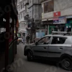 Cars Passing on Thin Market Road in Gangtok - Log, colour and B&W