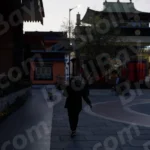 Woman Walking Inside Monastery - Log, colour and B&W