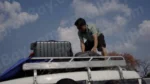 Man Putting Luggage on Top of a Car - Log, colour and B&W