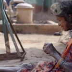 A Tribal Woman Weaving - Log, colour and B&W