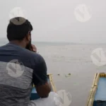 A Man Travleing On a Boat in a Lake - Log, colour and B&W