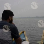 A Man Sit on a Boat in a Lake - Log, colour and B&W