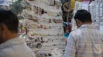 Man Selling Earrings in a Market - Log, colour and B&W