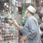 Old Man Selling Sunglasses - Log, colour and B&W