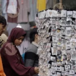 Boy Selling earrings in a Market - Log, colour and B&W