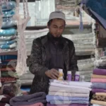 Man Selling Clothes - Log, colour and B&W